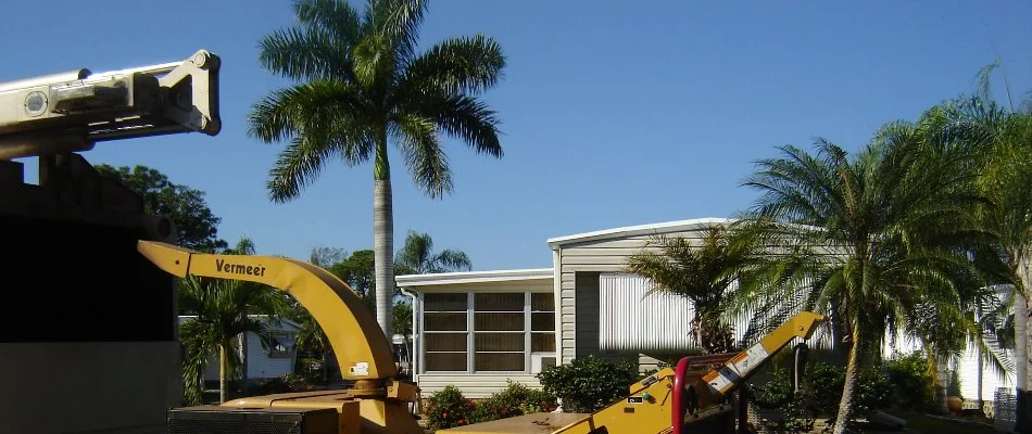 Our equipment parked on a property in Iona, FL for palm tree trimming.