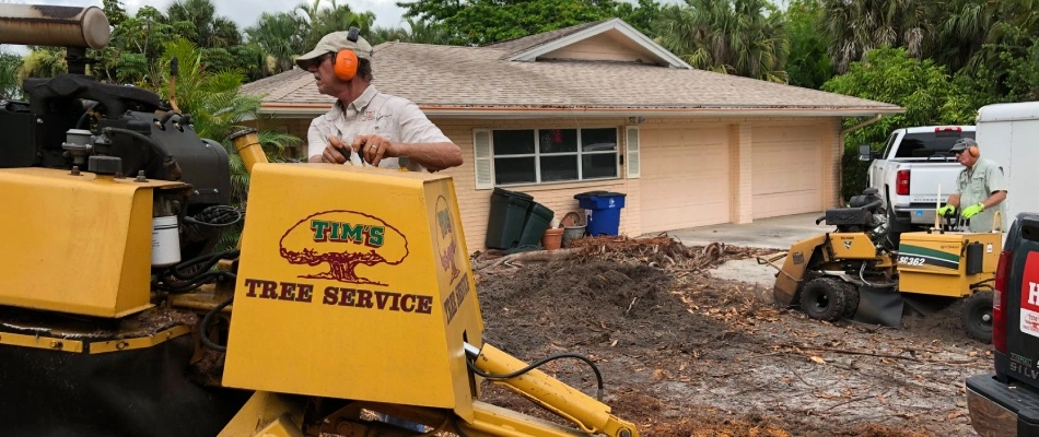 Professional using a stump grinder machine in Iona, FL.